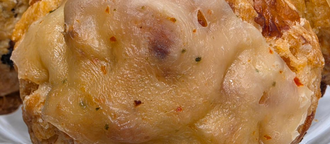 Savory smoked cheese scones with flaky layers served on a plate
