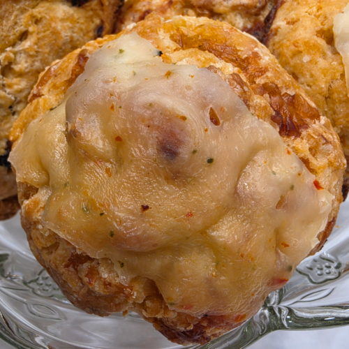 Savory smoked cheese scones with flaky layers served on a plate