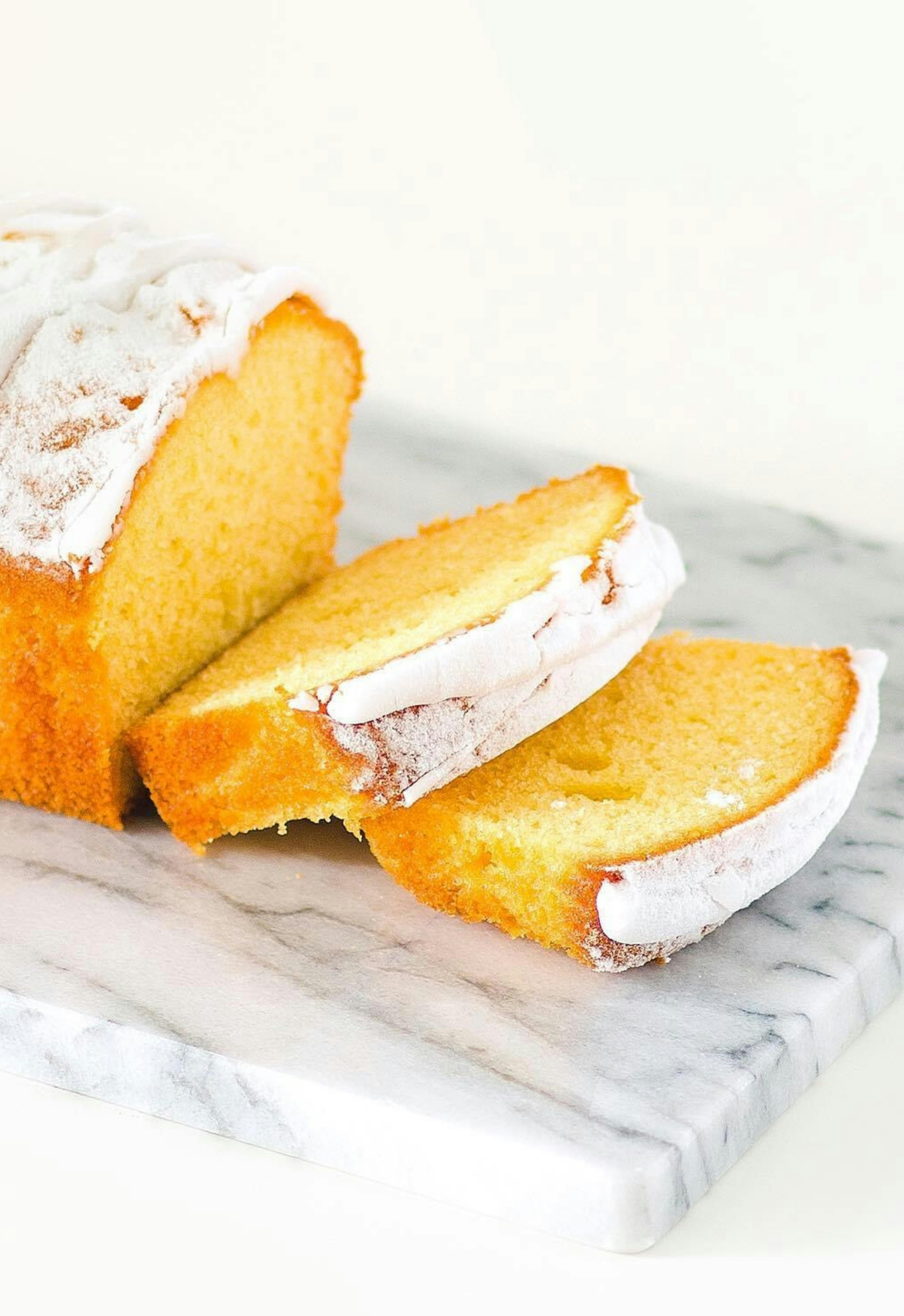 Moist traditional pound cake sliced on wooden board
